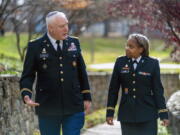 Head National Guard chaplain Col. Larry Bazer, deputy director of the chaplain office, left, and Chaplain Maj. A'Shellarien Lang, right, speak at the National Guard Bureau in Arlington, Va., Friday, Dec. 17, 2021.