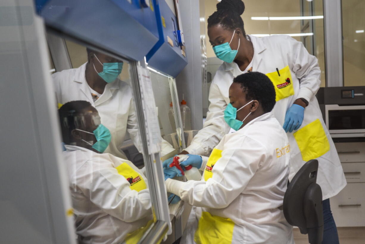 FILE -- Melva Mlambo, right, and Puseletso Lesofi, both medical scientists prepare to sequence COVID-19 omicron samples at the Ndlovu Research Center in Elandsdoorn, South Africa, Dec. 8, 2021.