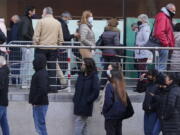 People queue for Pfizer COVID-19 vaccinations in the Wizink Center in Madrid, Spain, Wednesday, Dec. 1, 2021. Health authorities in the Spanish capital have confirmed a second case of the omicron coronavirus variant in a 61-year-old woman who had returned from a trip to South Africa on Monday.