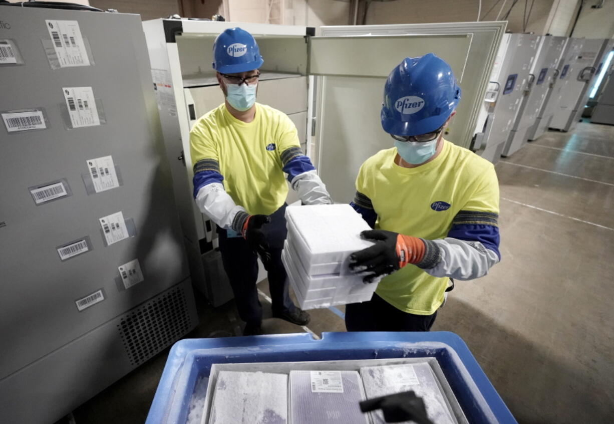 FILE - Boxes containing the Pfizer COVID-19 vaccine are prepared to be shipped at the Pfizer Global Supply Kalamazoo manufacturing plant in Portage, Mich., Dec. 13, 2020. The nation's COVID-19 death toll stands at around 800,000 as the anniversary of the U.S. vaccine rollout arrives. A year ago it stood at 300,000. What might have been a time to celebrate a scientific achievement is fraught with discord and mourning.