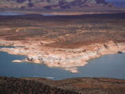 A boat moves along Wahweap Bay along the Upper Colorado River Basin, Wednesday, June 9, 2021, at the Utah and Arizona border near Wahweap, Ariz. Included in the infrastructure deal that became law last month is $2.5 billion for Native American water rights settlements, which quantify individual tribes' claims to water and identify infrastructure projects to help deliver it to residents. On the Navajo Nation, the largest reservation in the U.S., the money could fund a settlement reached in 2020 over water in the upper Colorado River basin.  (AP Photo/Ross D.