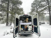 Millie looks out of the back of the Cabana van on a snowy morning in Grand Canyon National Park.