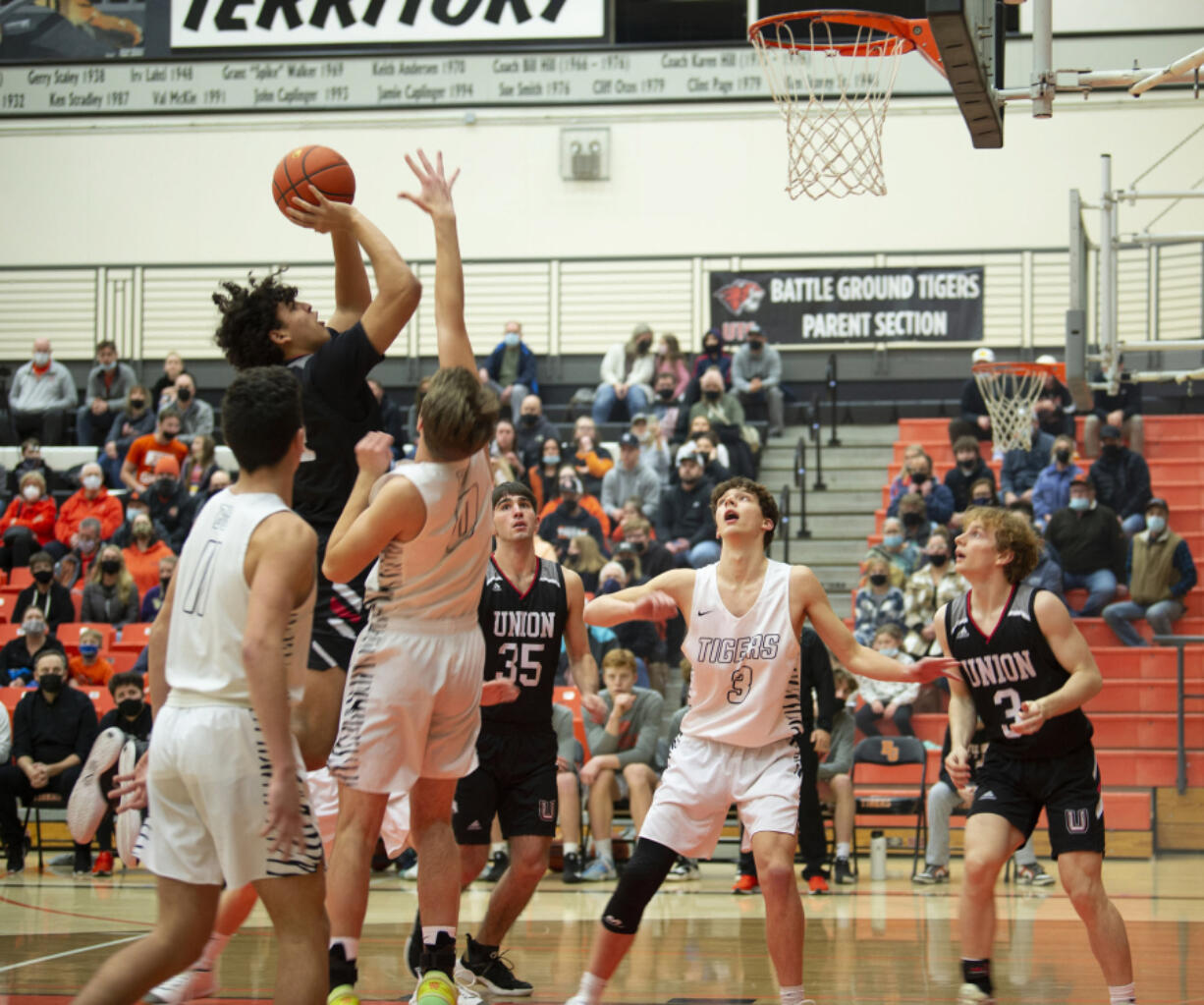 Union's Yanni Fassillis, left, puts up a shot in the paint over Battle Ground's Austin Ralphs (0) during Friday's 4A GSHL game.