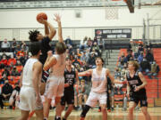 Union's Yanni Fassillis, left, puts up a shot in the paint over Battle Ground's Austin Ralphs (0) during Friday's 4A GSHL game.