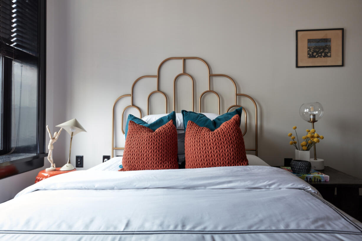 A scalloped iron headboard adds a feminine touch in this bedroom.