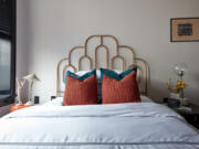 A scalloped iron headboard adds a feminine touch in this bedroom.