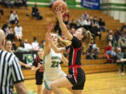 Camas junior Anna Mooney drives for a layup against Tumwater's Isabella Lund on Monday in Tumwater.