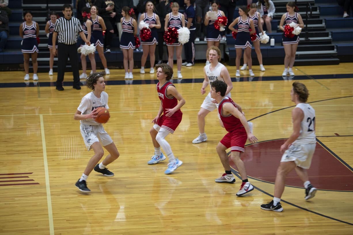 King's Way Christian guard Giovanny Evanson looks to make a pass during the Knights' 43-42 win over Castle Rock on Tuesday, Jan.