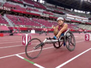 Yen Hoang waves to the camera prior to her heat in the T53 800 meters at the Paralympic Games at Tokyo.