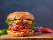 Homemade plant based burger made from sweet potato, black beans and brown rice on a whole wheat brioche bun; copy space (iStock.com)