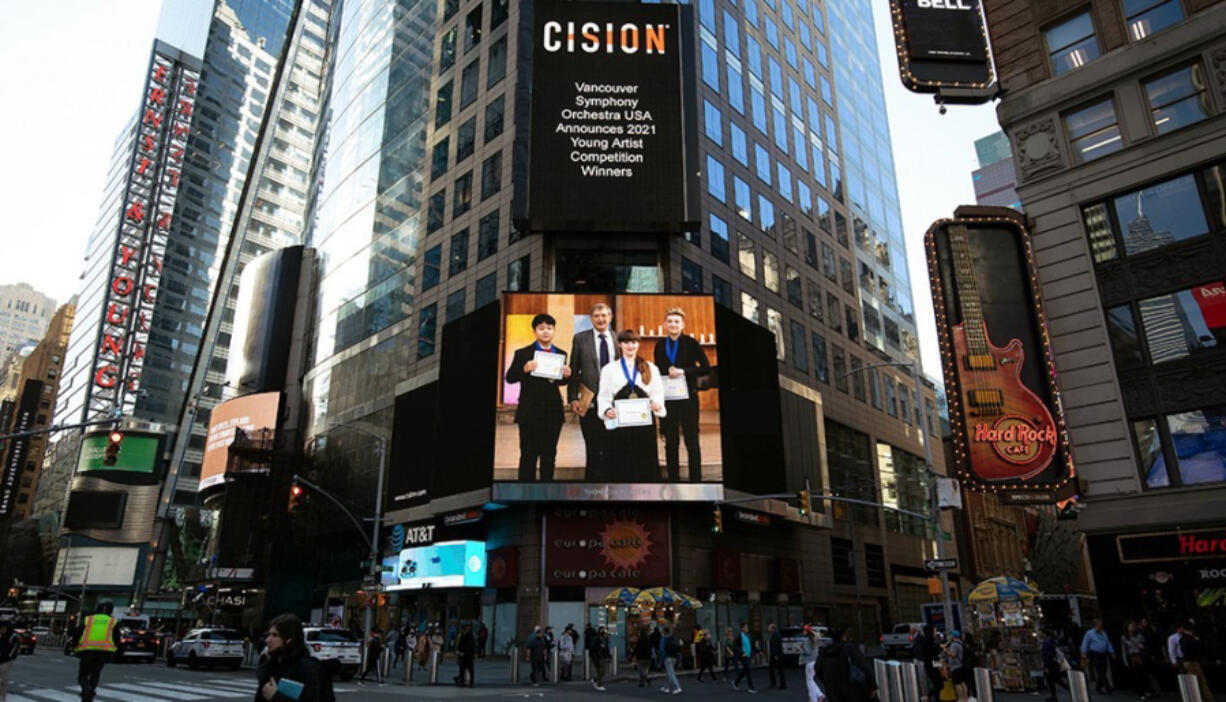 The Vancouver Symphony Orchestra's Young Artists competition has expanded to the national level, which is why this ad featuring Maestro Salvador Brotons and the contest's three winners beamed from Times Square in New York City.