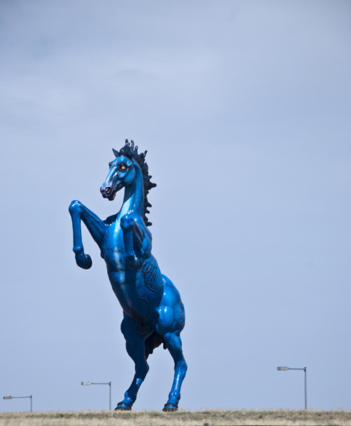 A sculpture by artist Luis Jim?(C)nez at Denver International Airport. The horse is blue due to a local legend about a powerful blue horse that could fly.