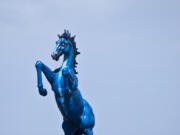 A sculpture by artist Luis Jim?(C)nez at Denver International Airport. The horse is blue due to a local legend about a powerful blue horse that could fly.