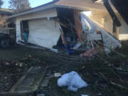 The garage of a house in the 14100 block of Southeast McGillivray Boulevard was destroyed after a driver who police say was impaired and speeding crashed into it Monday morning. Some pedestrians reported narrowly avoiding being hit by the driver before he crashed.