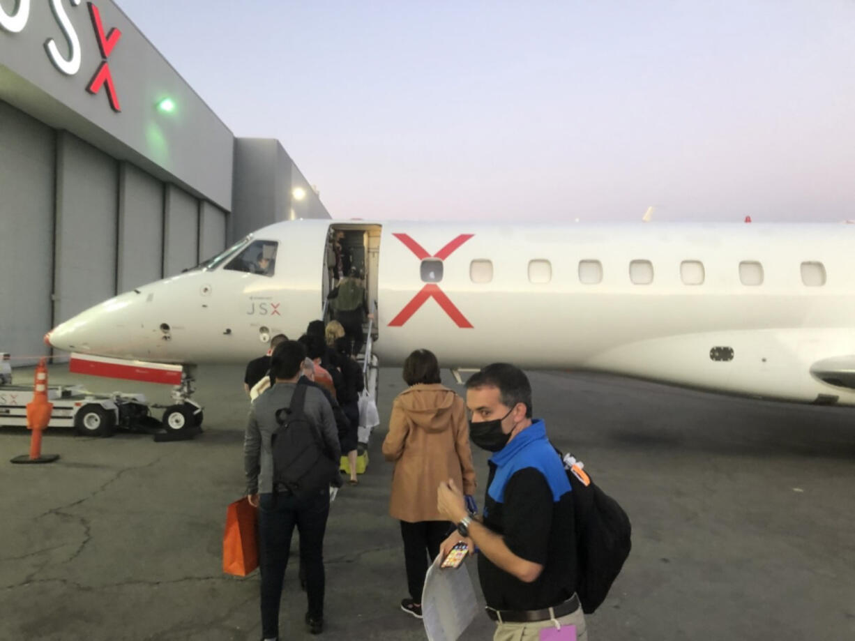 Passengers wait to board a JetBlue JSX flight bound for Burbank. Growth in so-called ???bleisure??? trips blending personal getaways with remote work has helped fill seats on planes during the coronavirus pandemic and marks a shift in travel patterns for the airline industry.