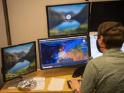 PLEXSYS Test Technician Robert Tomlinson runs simulation software on a computer at the PLEXSYS office in Camas. The company's technology is used to train air forces and, soon, space forces.