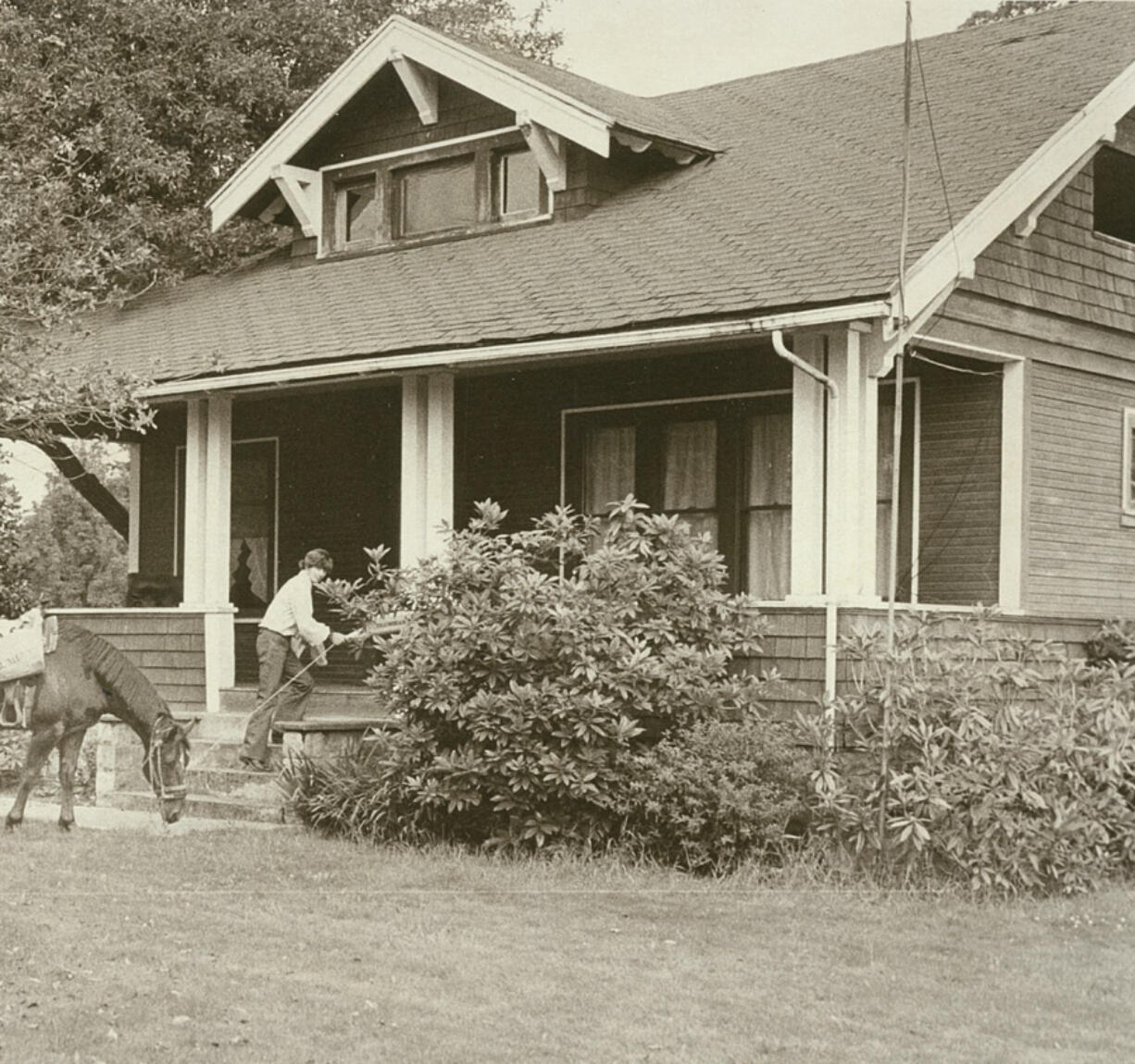 Cliff Blackburn and Brandy deliver The Columbian in July 1976 somewhere in east Clark County. At top, Phouthong Bonglamphone, left, and Tuy Khounphachansy used a wheelbarrow to deliver newspapers in December 1985 because their bicycles were stolen.