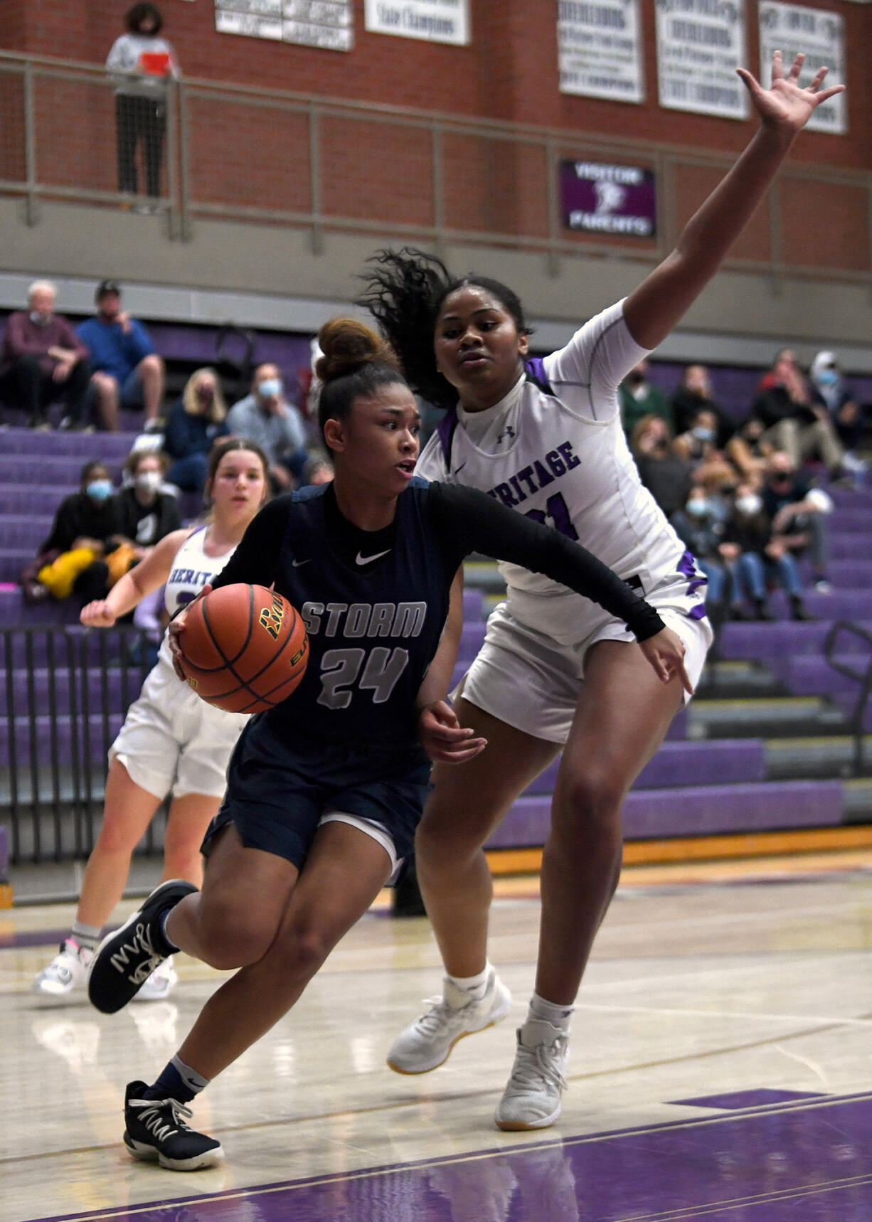 Skyview junior Jordan Labrador-Hallett, left, moves around Heritage junior Keanna Salavea on Tuesday, Jan. 4, 2022, during the Storm’s 66-40 win against the Timberwolves at Heritage High School.