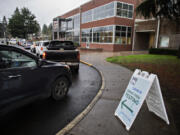 A line of students and faculty from Vancouver Public Schools gather outside the Jim Parsley Center for free drive-thru COVID-19 screening Thursday afternoon.