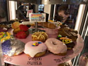 Ridgefield resident James Tobin, 8, tries to decide which doughnut to get while looking over the selection at the new Voodoo Doughnut at Vancouver Mall on Tuesday morning, Jan.11, 2022.