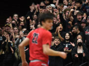 Camas students celebrate a basket Wednesday, Jan. 12, 2022, during the Papermakers’ 72-60 loss to the Titans at Union High School.
