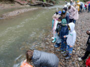 Union Ridge Elementary students gather Gee Creek to release the young salmon they raised in their classroom tank.