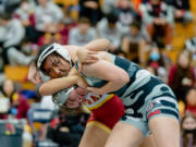 Prairie's Yana Paskar throws Union's Grace Strong at the Norm Friehauf Clark County Championships on Saturday, Jan. 15, 2022, at Skyview High School.