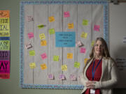 Lillie Shaver, a social-emotional learning center clerk at Chief Umtuch Middle School in Battle Ground, is surrounded by inspirational messages in the school's Wolverine Den on Friday morning. The program is a part of a districtwide effort to provide social-emotional support to students acting out in class in place of punishment or an interruption of learning.