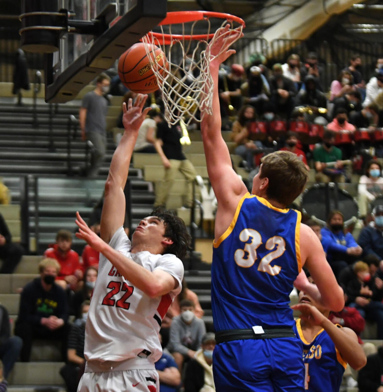 Camas senior Carson Frawley, left, shoots the ball Friday, Jan. 21, 2022, during the Papermakers??? 83-38 win against the Hilanders at Camas High School.