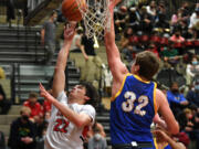Camas senior Carson Frawley, left, shoots the ball Friday, Jan. 21, 2022, during the Papermakers??? 83-38 win against the Hilanders at Camas High School.