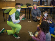 Malcolm Reed, left, dressed as the tooth fairy, signs "thank you" to a student on Tuesday, following Delta Dental of Washington's "The Tooth Fairy Experience" presentation at the Washington School for the Deaf in Vancouver. Excited students were given gift bags with dental health items after the event.