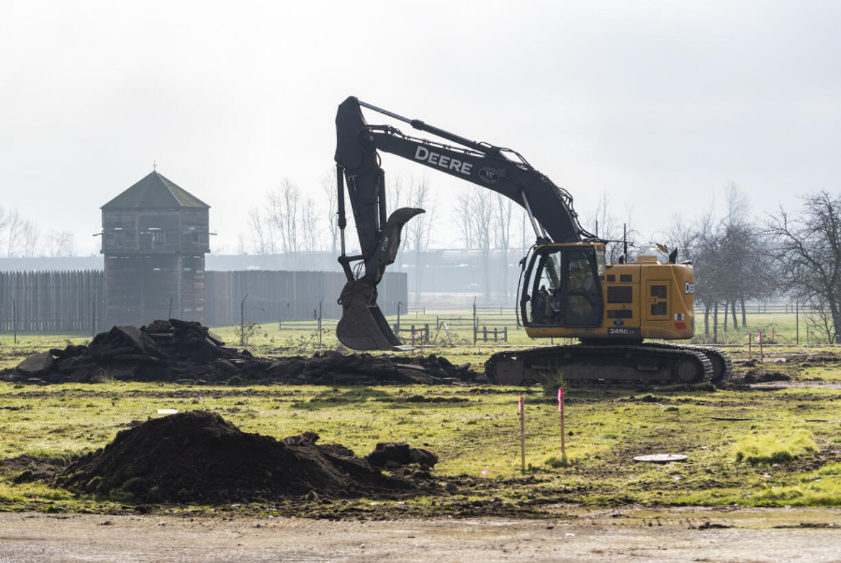 An excavator works Wednesday at Fort Vancouver National Historic Site. Improvements are being made to East Fifth Street and a new parking lot is being added as part of a project scheduled for completion in September.