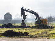 An excavator works Wednesday at Fort Vancouver National Historic Site. Improvements are being made to East Fifth Street and a new parking lot is being added as part of a project scheduled for completion in September.