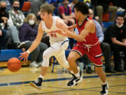 Ridgefield's Henry Hughes (21) attempts to get down the court while being defended by R. A. Long's Jamond Harris (14) during the first quarter of a basketball game at Ridgefield High School on Thursday, January 27, 2022.