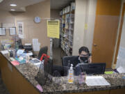 Sam Sugarman, patient service representative for Northwest Medical Associates-Praxis Health, takes a call while working at the front desk on Thursday afternoon. Praxis Health, Oregon's largest independent medical group, has expanded into Vancouver after recently acquiring Northwest Medical Associates, a 35-year-old clinic in east Vancouver.