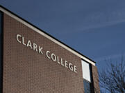 Morning sun illuminates a sign on the side of a building at Clark College in Vancouver on a Friday morning in January 2022.