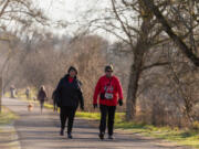 Cascade Park Kiwanis members Patty and Mike Downey chat as they walk during Clark Public Utilities' annual Race for Warmth event on Saturday. Carole Mackey, the membership chair for the Rotary Club of Three Creeks, organized a group of racers to participate in the event at Klineline Pond in Vancouver.