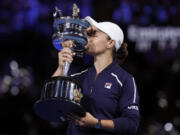 Ash Barty of Australia kisses the Daphne Akhurst Memorial Cup after defeating Danielle Collins of the U.S., in the women's singles final at the Australian Open tennis championships in Saturday, Jan.