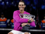 Rafael Nadal of Spain holds the Norman Brookes Challenge Cup after defeating Daniil Medvedev of Russia in the men's singles final at the Australian Open tennis championships in Melbourne, Australia, early Monday, Jan. 31, 2022.