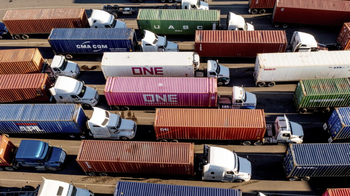 FILE - Trucks line up to enter a Port of Oakland shipping terminal on Nov. 10, 2021, in Oakland, Calif. The pandemic has receded as a top priority in many voters' minds to start 2022, with the economy overshadowing coronavirus concerns and worries about inflation on the rise, a poll from The Associated Press-NORC Center for Public Affairs Research finds.