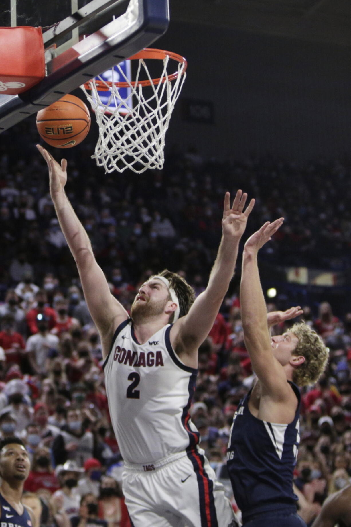 Gonzaga forward Drew Timme, left, shoots in front of BYU forward Caleb Lohner during the first half of an NCAA college basketball game, Thursday, Jan. 13, 2022, in Spokane, Wash.