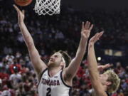 Gonzaga forward Drew Timme, left, shoots in front of BYU forward Caleb Lohner during the first half of an NCAA college basketball game, Thursday, Jan. 13, 2022, in Spokane, Wash.