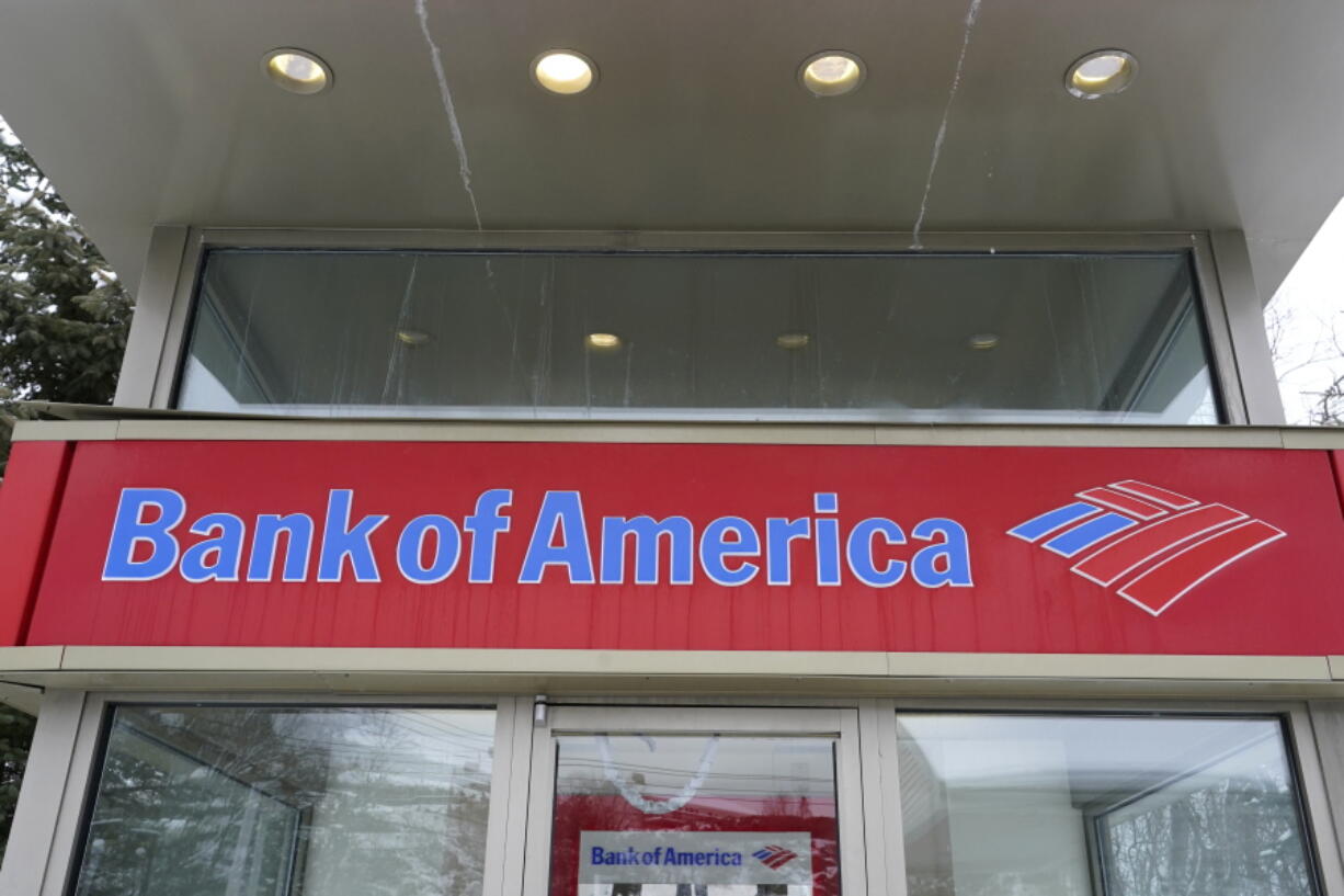 A Bank of America ATM is seen, Wednesday, Feb. 3, 2021, in Winchester, Mass.  Bank of America is slashing the amount it charges customers when they spend more than they have in their accounts and plans to eliminate entirely its fees for bounced checks. The Charlotte-based bank will cut the fee it charges customers to overdraft to $10 from $35 starting in May 2022.