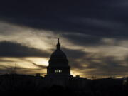 FILE - The U.S. Capitol is seen in Washington, early Dec. 17, 2021. President Joe Biden faces a steep path to achieve his ambitious goal to slash planet-warming greenhouse gas emissions in half by 2030, as a $2 trillion package of social and environmental initiatives remains stalled.  Biden's Build Back Better plan, which contains $550 billion in spending and tax credits aimed at promoting clean energy, was sidetracked by Democratic Sen. Joe Manchin, who said just before Christmas that he could not support the legislation as written. (AP Photo/J.