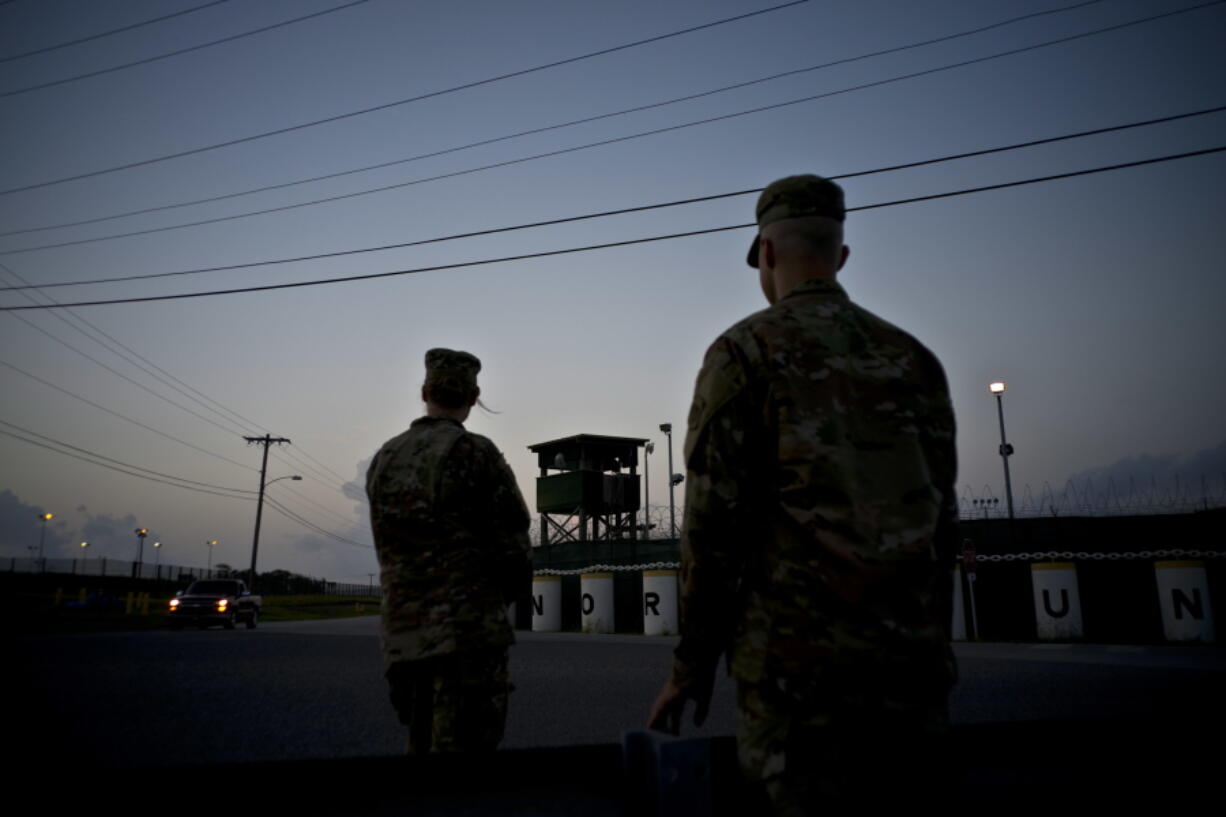 FILE - In this June 5, 2018 photo, reviewed by U.S. military officials, troops stand guard outside Camp Delta at the Guantanamo Bay detention center, in Cuba. The 20th anniversary of the first prisoners' arrival at the Guantanamo Bay detention center is on Tuesday, Jan. 11, 2022. There are now 39 prisoners left. At its peak, in 2003, the detention center held nearly 680 prisoners.