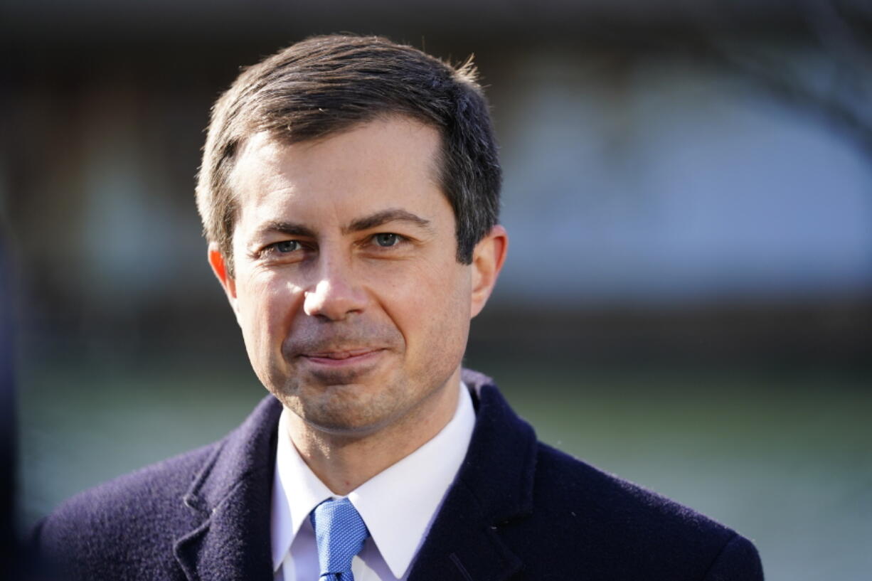 FILE - Transportation Secretary Pete Buttigieg listens at an event in Philadelphia, on Jan. 14, 2022. Buttigieg is vowing help to stem a rising U.S. epidemic of car fatalities with a broad-based government strategy aimed at limiting the speed of cars, redesigning roads to better protect bicyclists and pedestrians and boosting car safety features such as automatic emergency braking. Buttigieg indicated to The Associated Press that new federal data being released next week will show another spike in traffic fatalities through the third quarter of 2021.