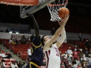 Washington State forward Andrej Jakimovski, right, shoots in front of California forward Kuany Kuany during the second half of an NCAA college basketball game, Saturday, Jan. 15, 2022, in Pullman, Wash.