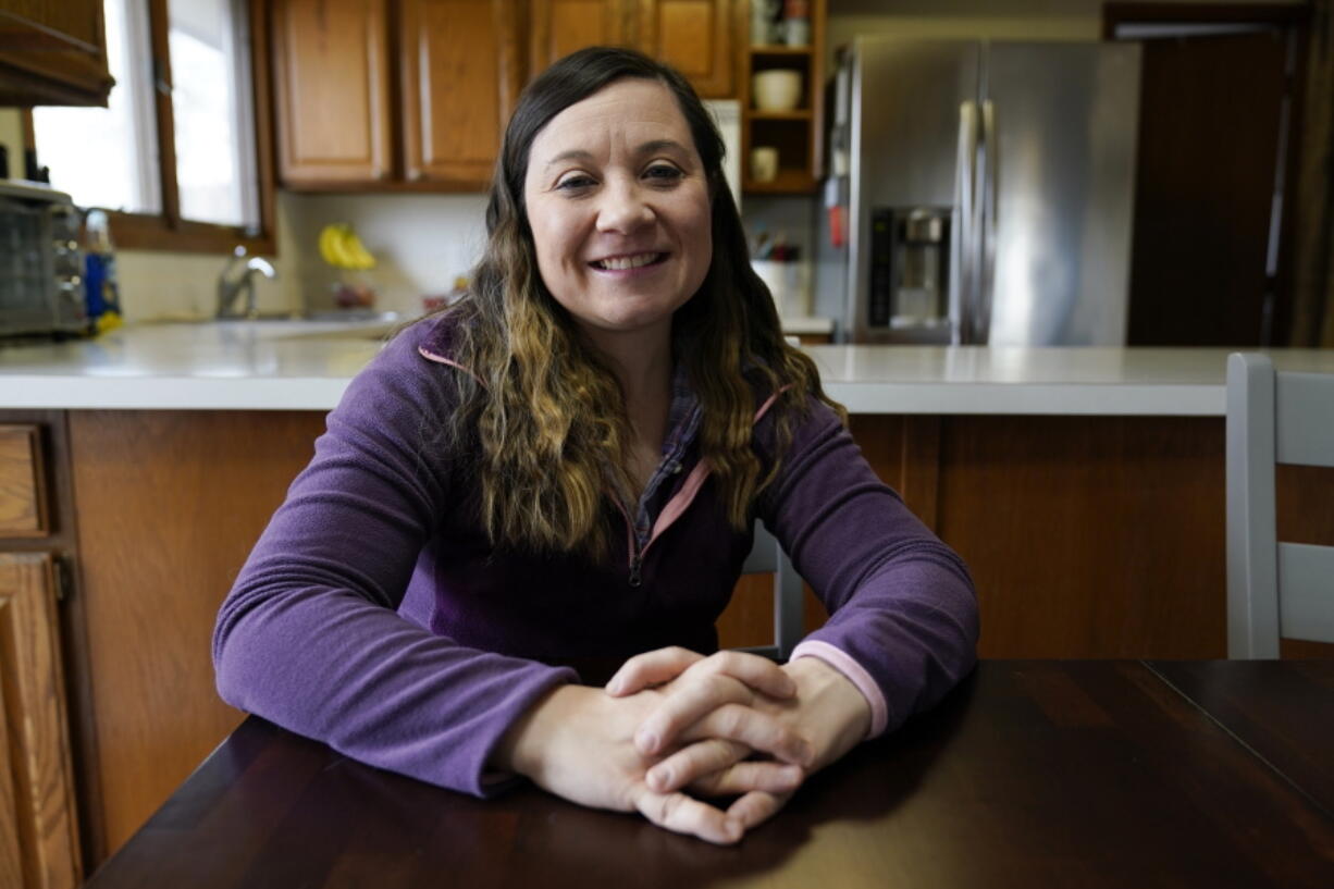 Waukee School District teacher Liz Wagner in her home, Thursday, Dec. 23, 2021, in Urbandale, Iowa. Teachers have already landed on the front lines of the culture war. Now the Jan. 6 anniversary is prompting some to decide how -- or whether -- to teach their students about the events that sit at the heart of the country's division.