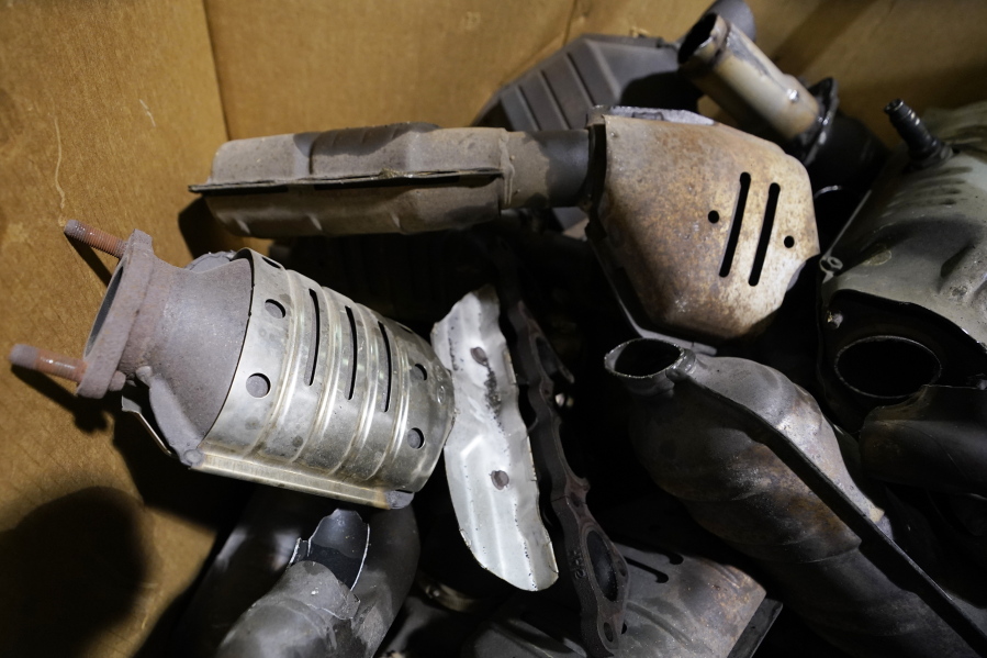 Used catalytic converter that was removed from cars at a salvage yard are piled up in a carton Friday Dec. 17, 2021, in Richmond, Va.