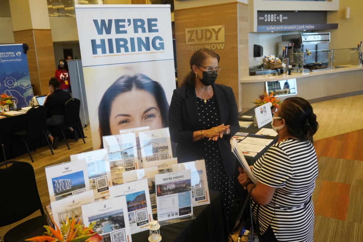 Marriott human resources recruiter Mariela Cuevas, left, talks to Lisbet Oliveros, during a job fair at Hard Rock Stadium, Friday, Sept. 3, 2021, in Miami Gardens, Fla. Federal Reserve policymakers at a meeting last month said the U.S. job market was nearly at levels healthy enough that the central bank's low-interest rate policies were no longer needed. That's according to minutes of the meeting released Wednesday, Jan. 5, 2022.